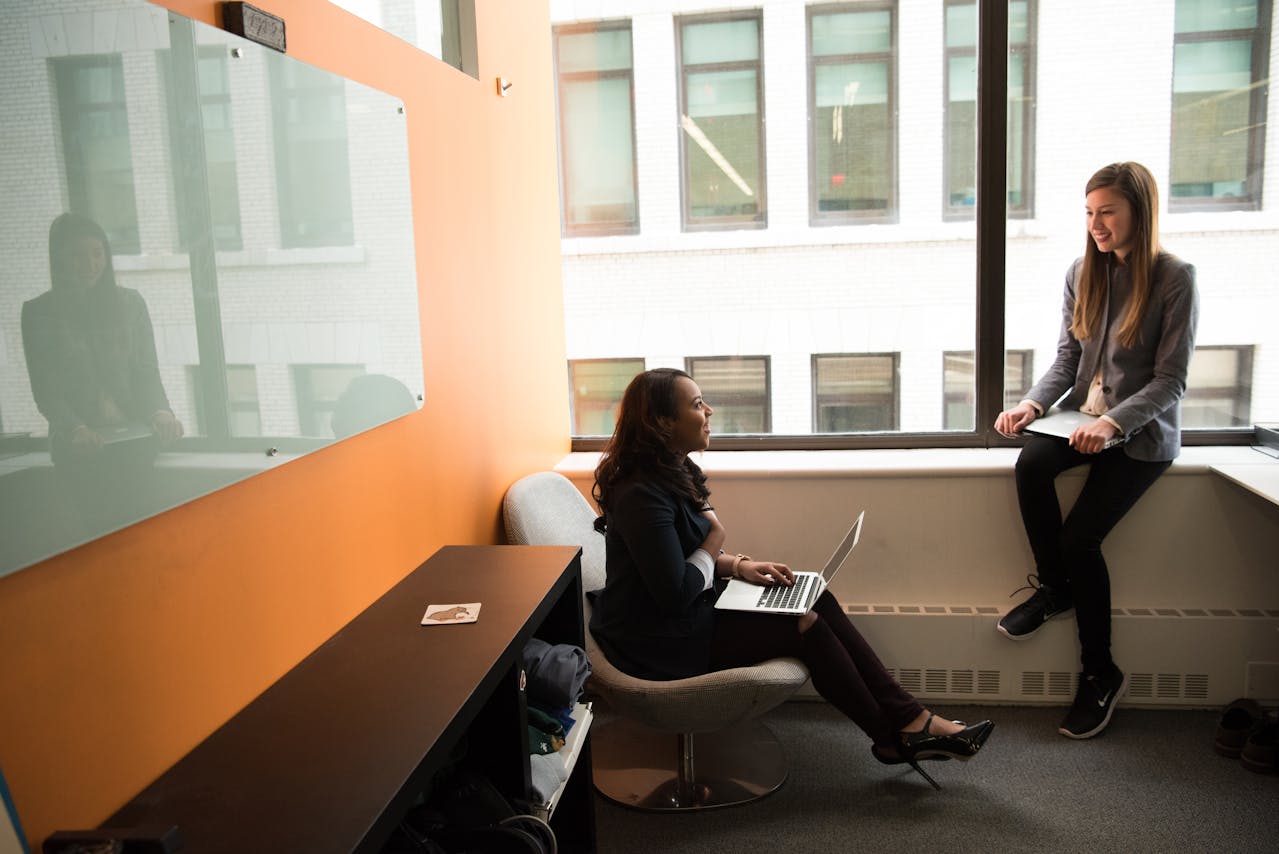 Two employees discussing the CA Fair Employment and Housing Act