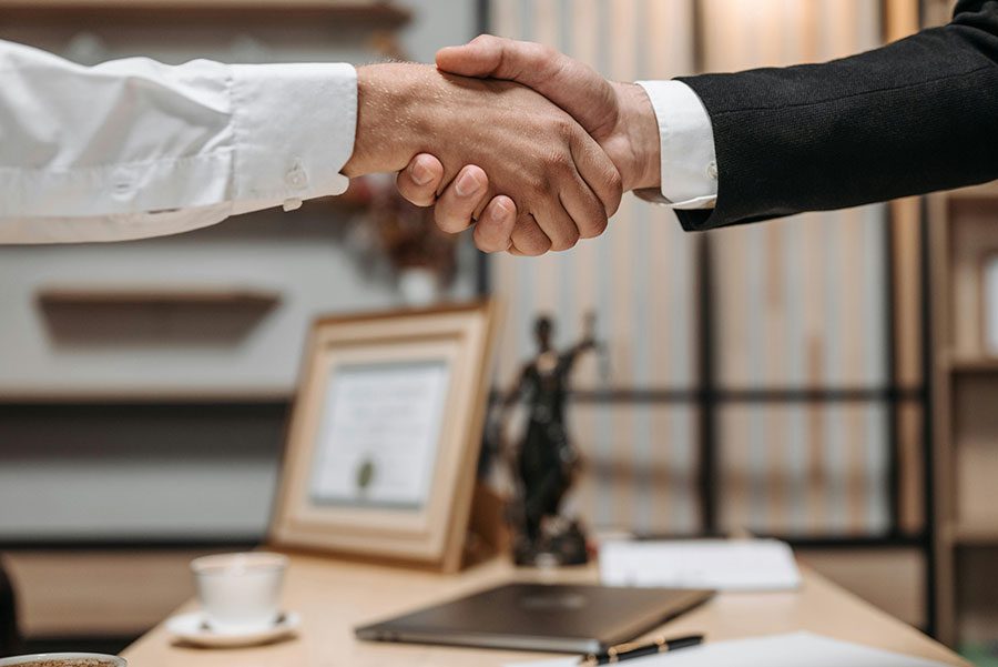 A client shaking hands with a lawyer