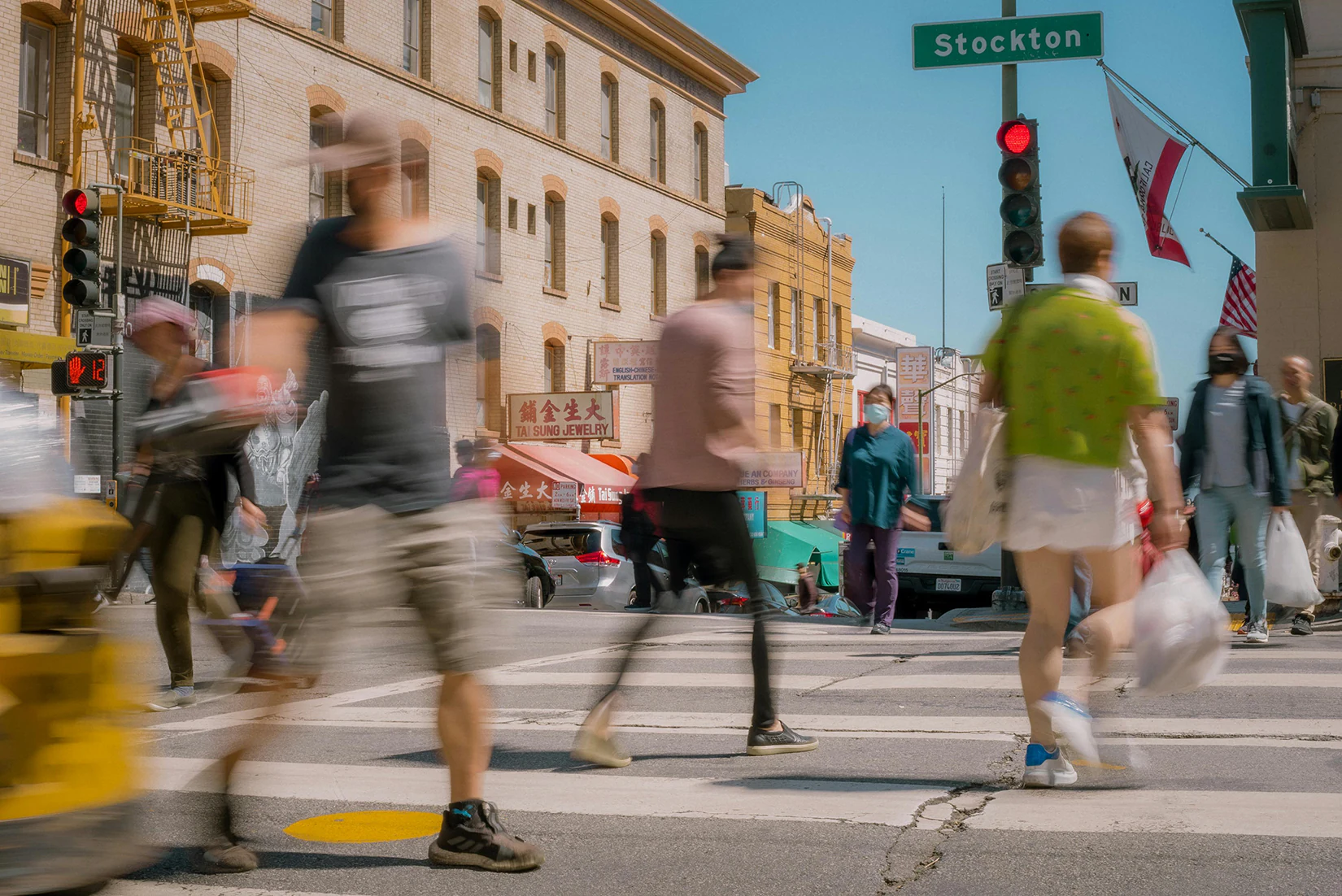 People walking on a crosswalk near a Stockton employment attorney’s office