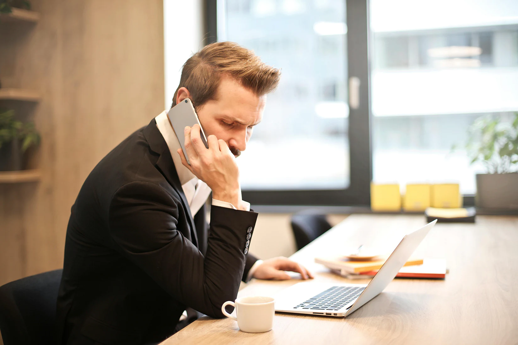 A person at their desk calling a lawyer