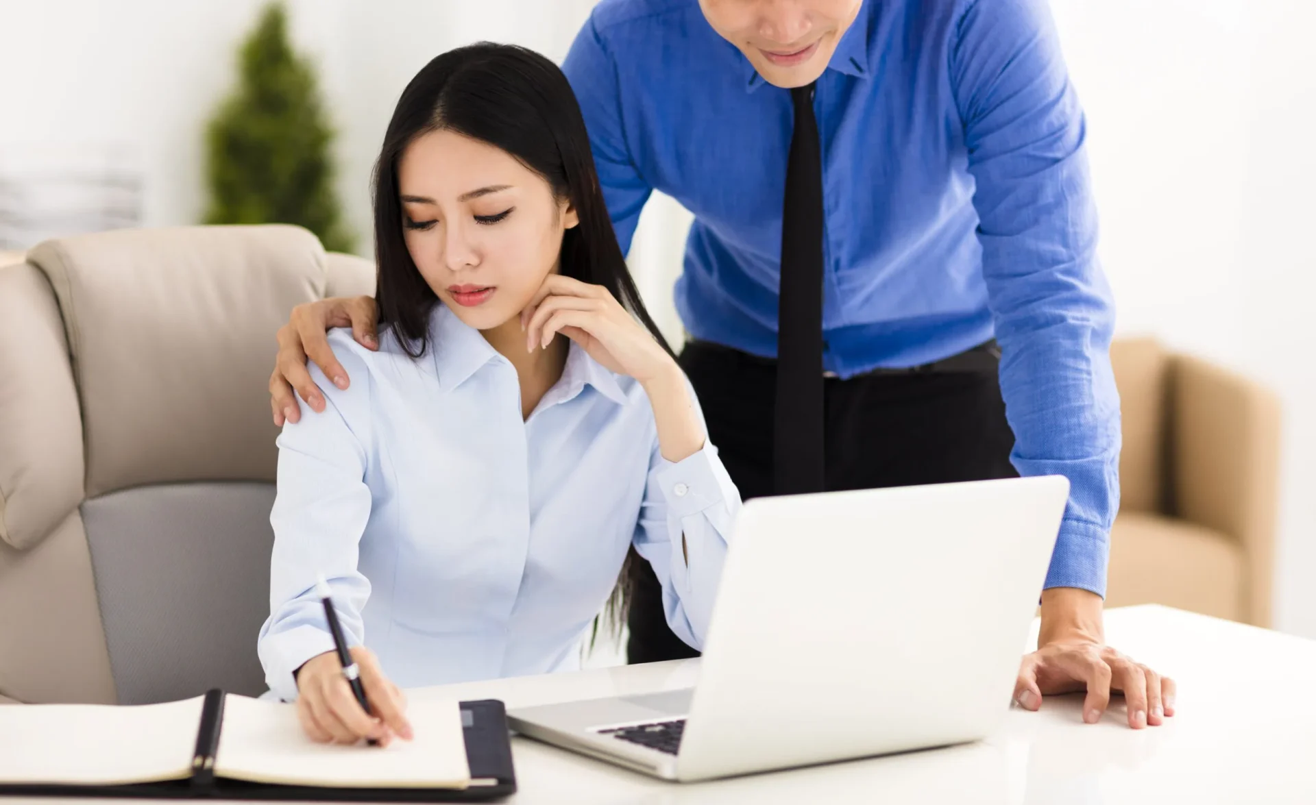 Man making unwelcome advance toward female coworker in a Roseville office.